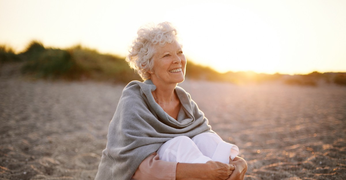 Happy senior woman at the beach