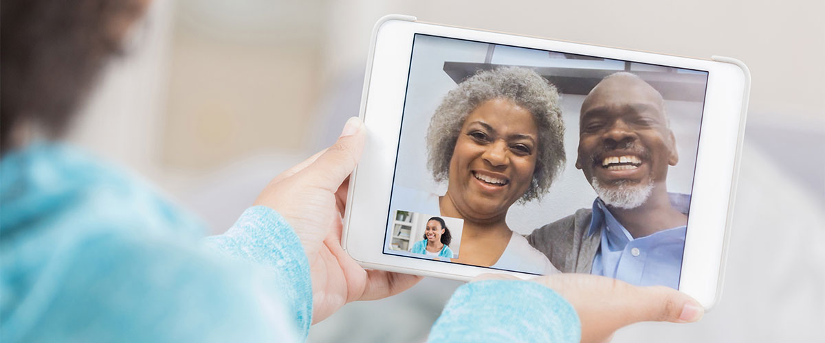 girl on a video call with senior parents