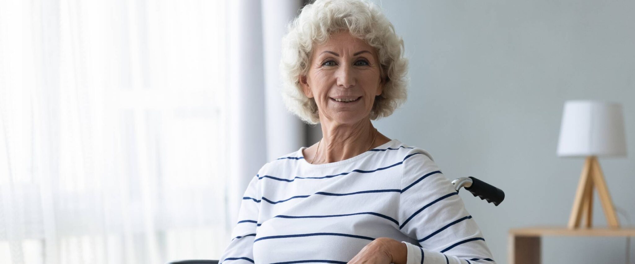 senior lady smiling in a wheelchair