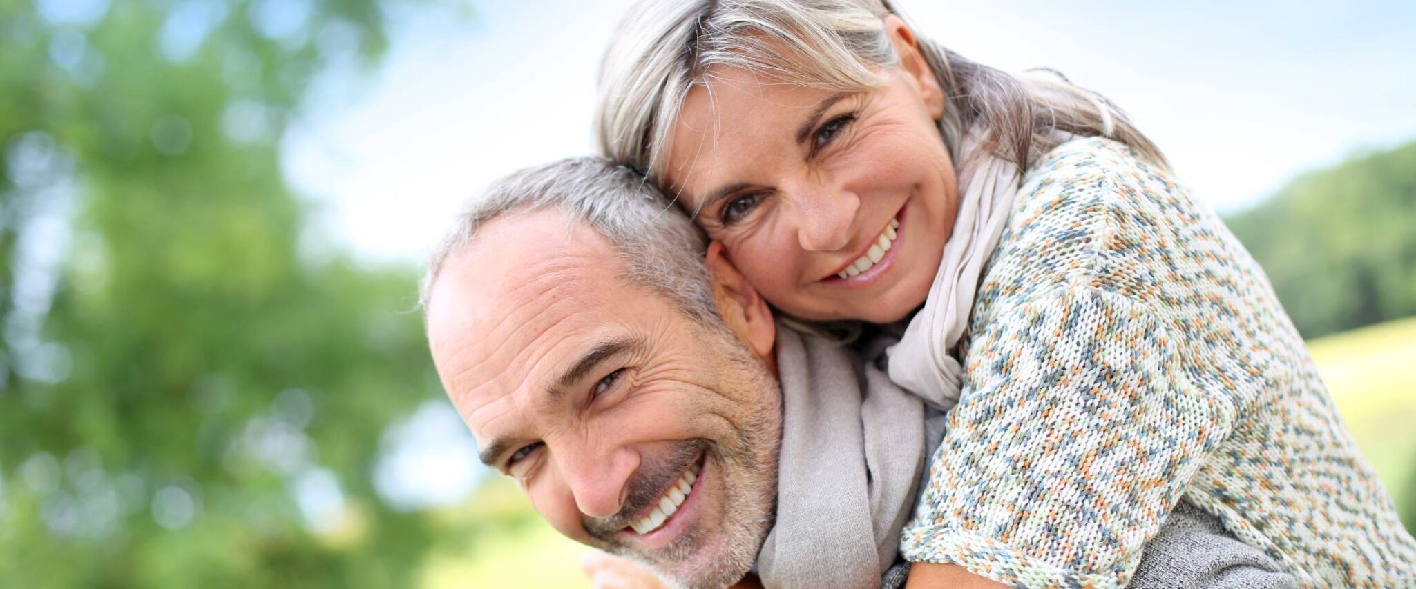 senior man and woman hugging each other outside