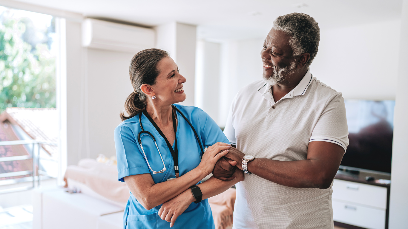 Nurse assisting senior man in home
