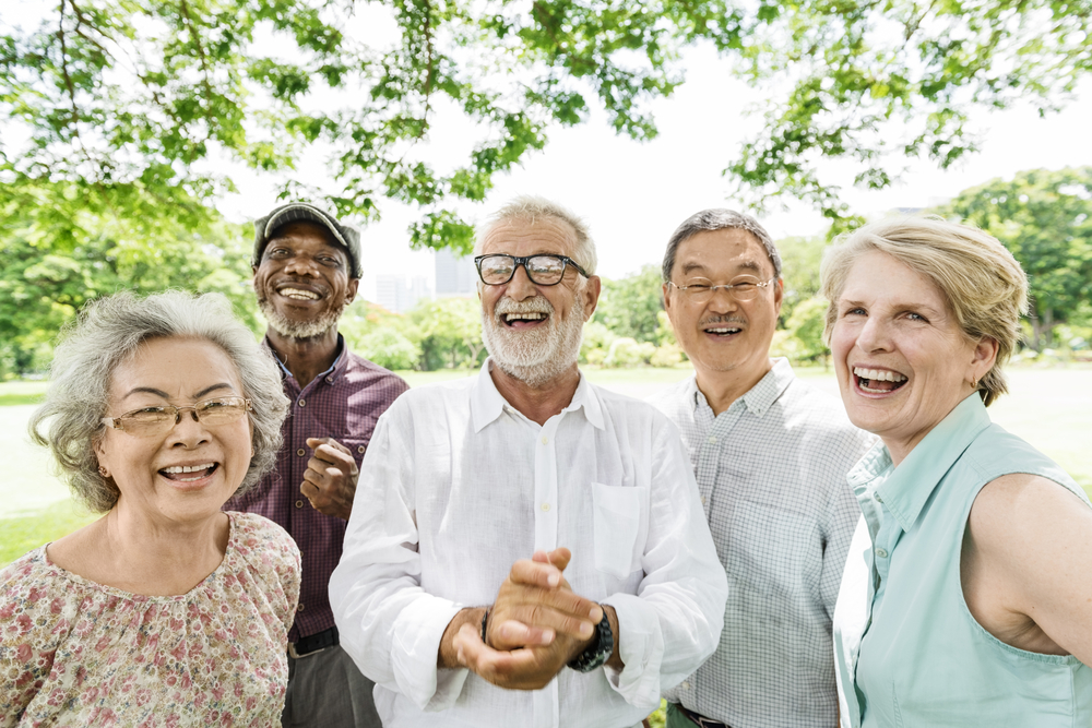 Senior friends laughing together outdoors