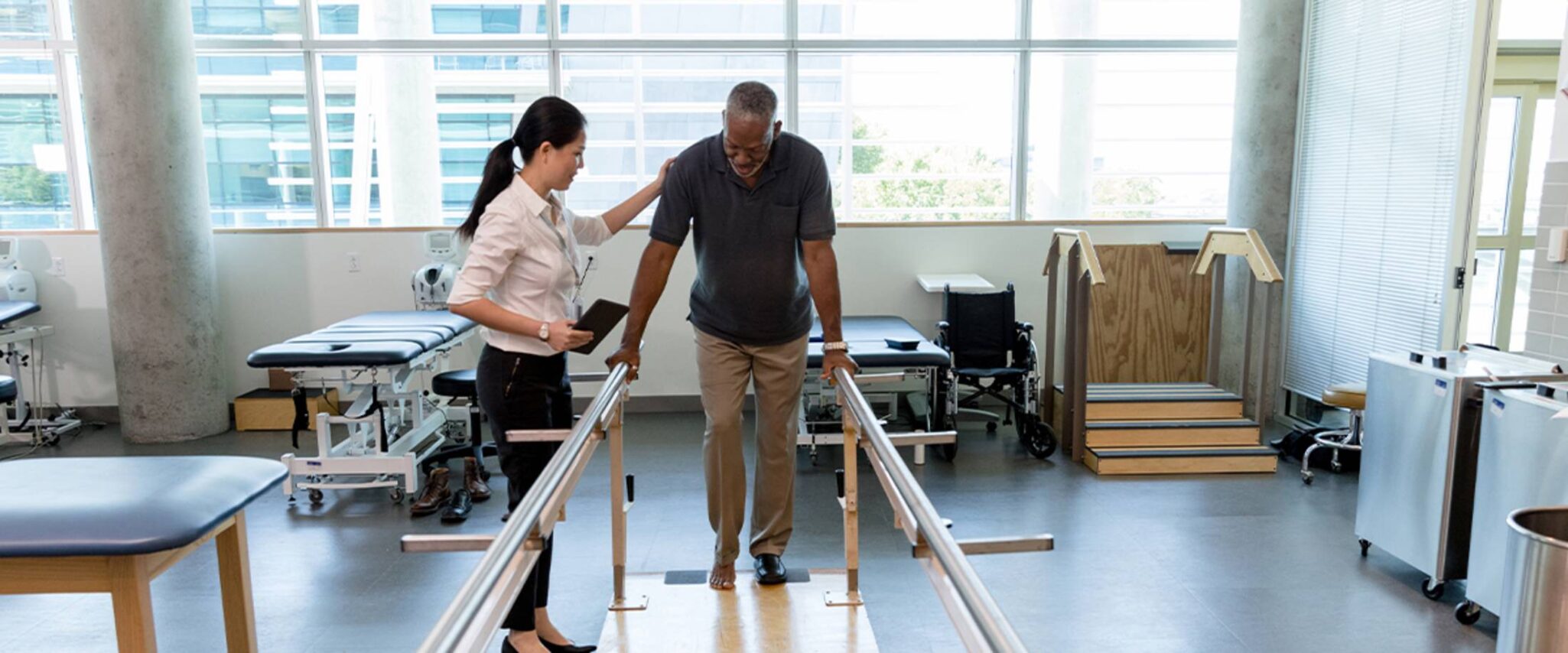 Healthcare worker helping a senior with rehab in a retirement community