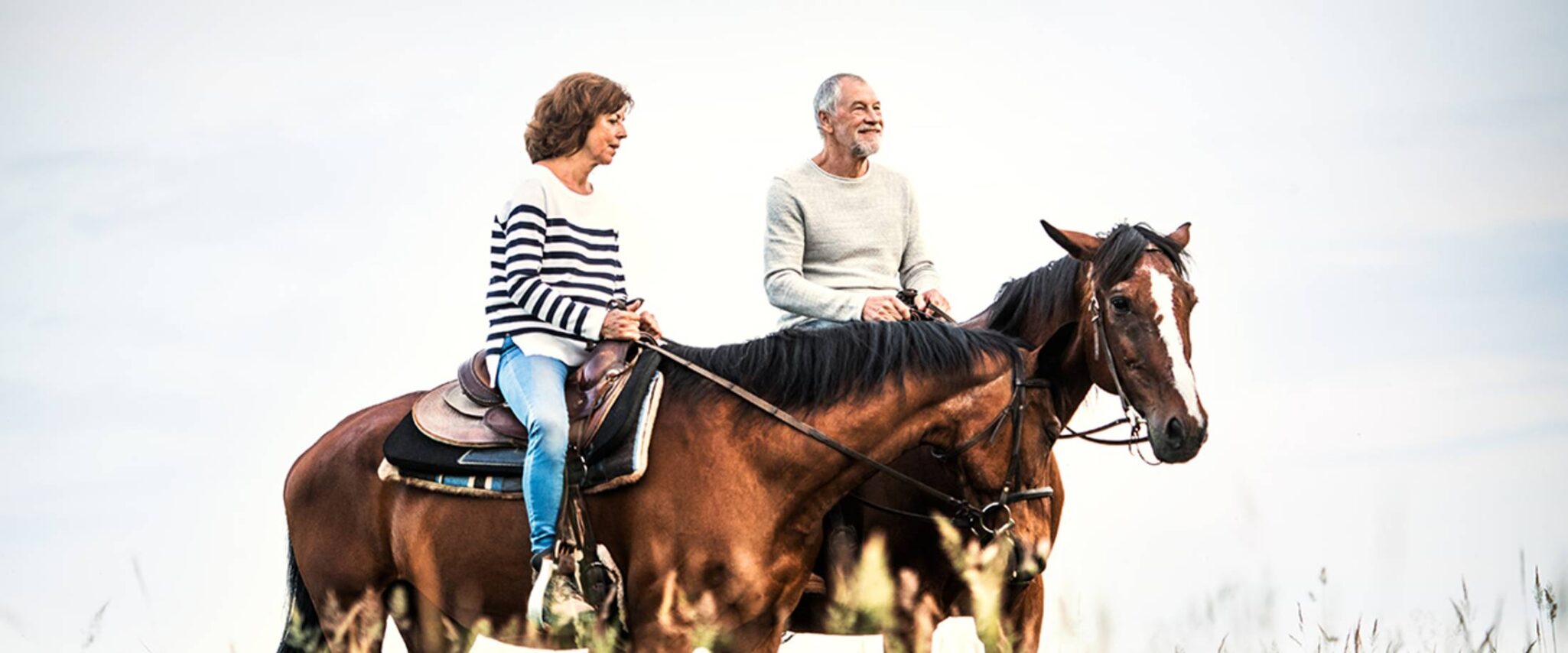 senior couple riding horses