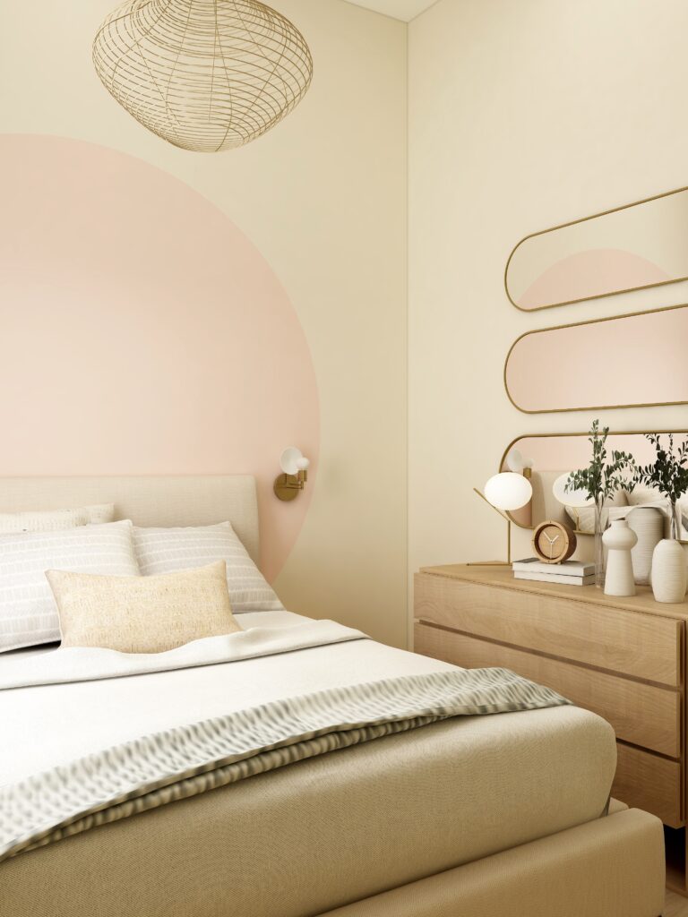 A bedroom with a soft pink circle painted on the wall acting like a headboard 