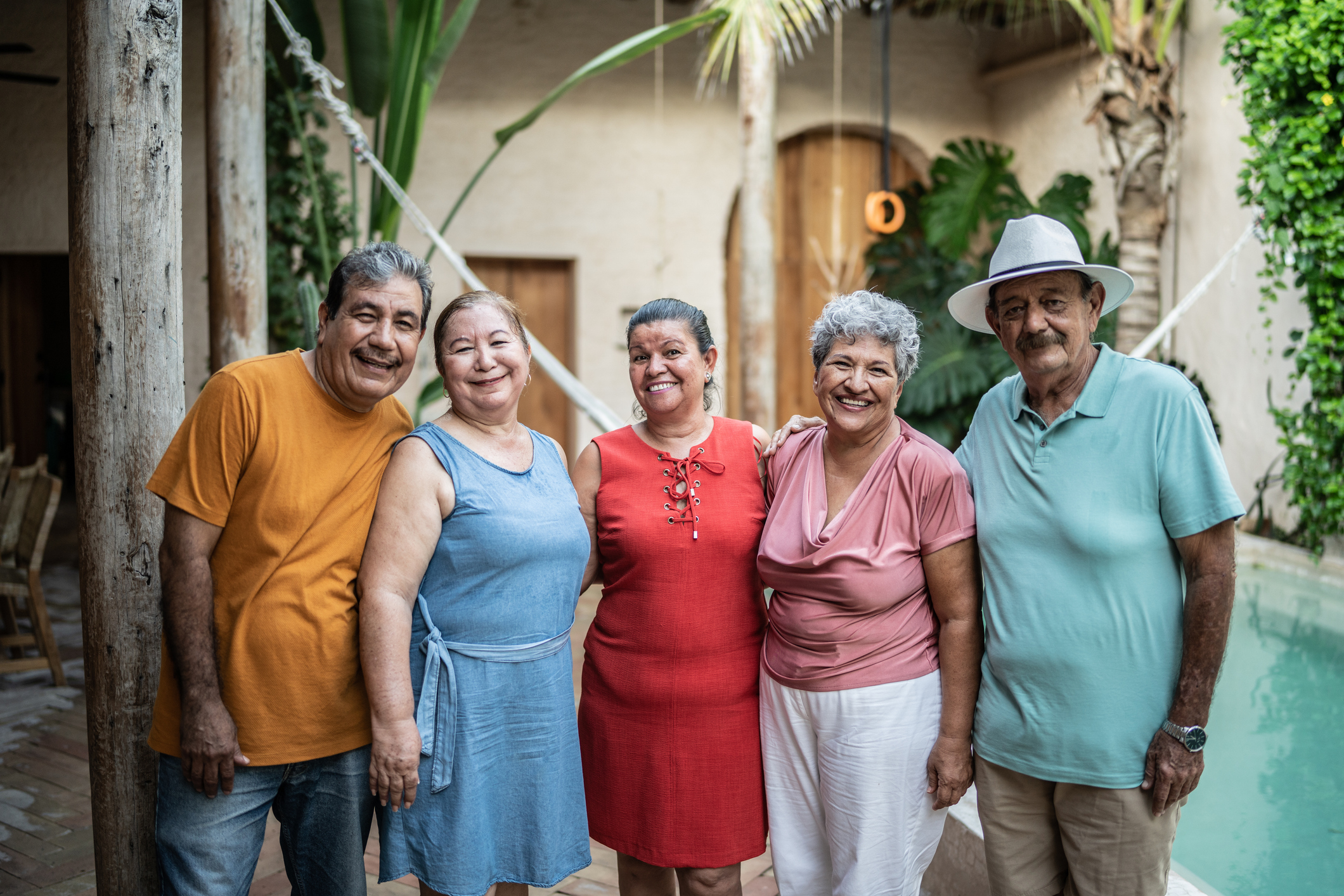 Group of senior friends smiling by pool